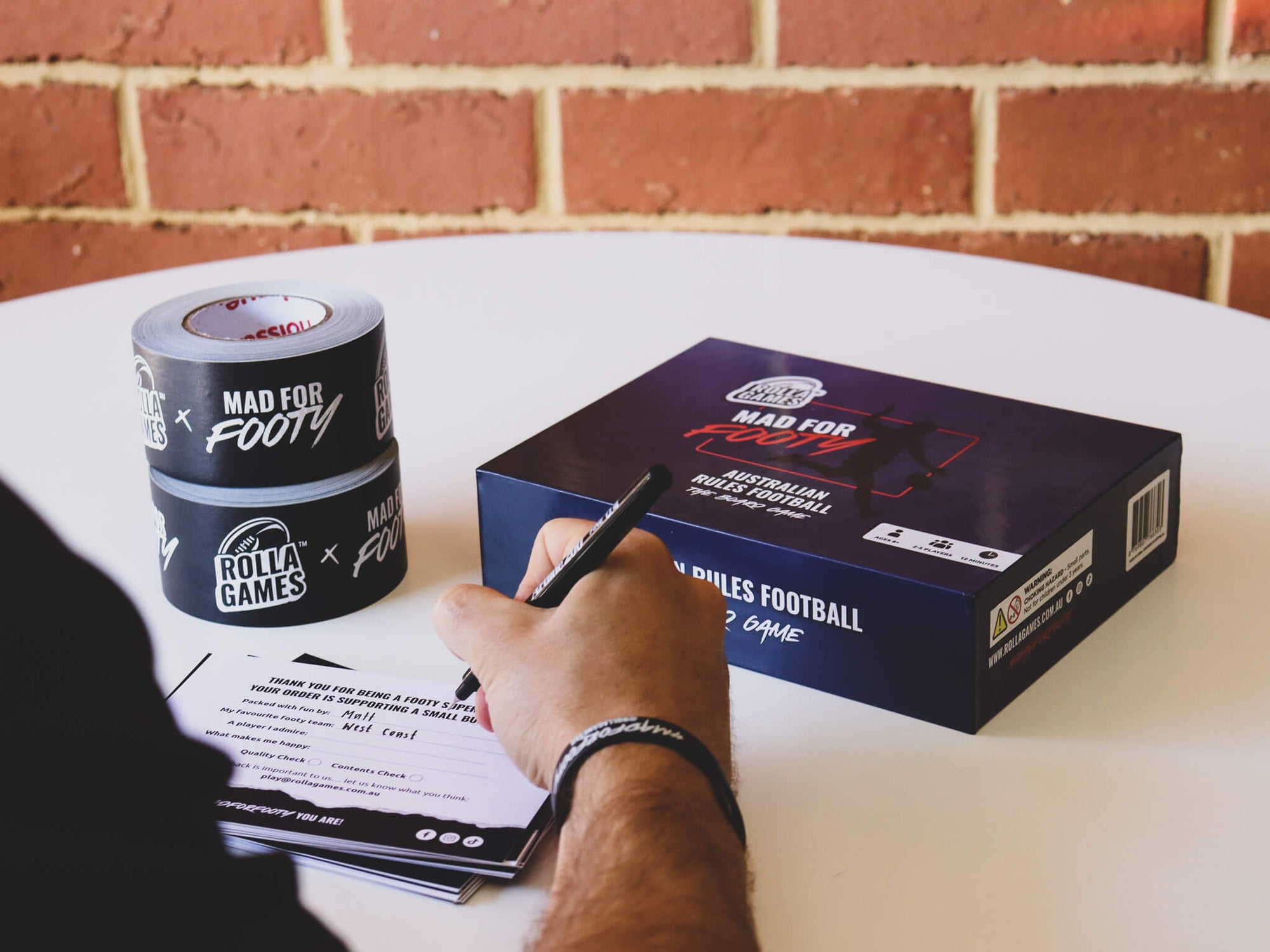 Writing a product thank you note to be packaged alongside an AFL family board game.