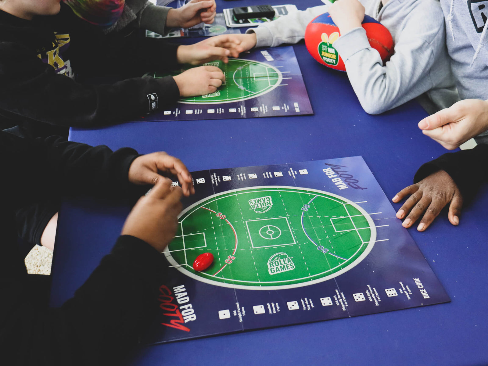 Children playing Australian Rules Football Board Game, Mad for Footy.